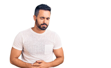 Young hispanic man wearing casual clothes with hand on stomach because indigestion, painful illness feeling unwell. ache concept.