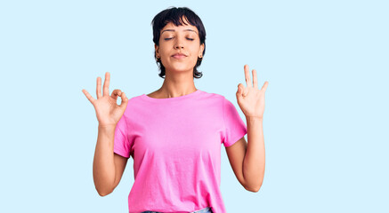 Young brunette woman with short hair wearing casual clothes relax and smiling with eyes closed doing meditation gesture with fingers. yoga concept.