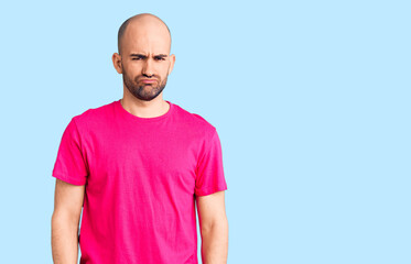 Fototapeta premium Young handsome man wearing casual t shirt depressed and worry for distress, crying angry and afraid. sad expression.