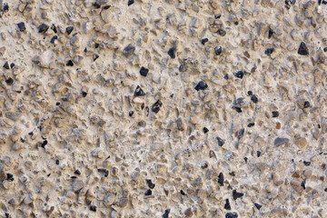 Cement wall with stones abstract background, obsidian stones