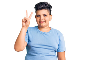 Little boy kid wearing sports workout clothes showing and pointing up with fingers number two while smiling confident and happy.