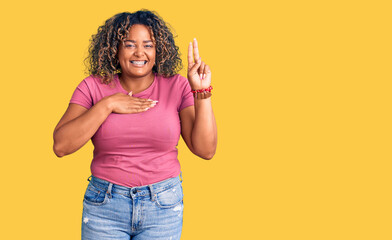 Young african american plus size woman wearing casual clothes smiling swearing with hand on chest...