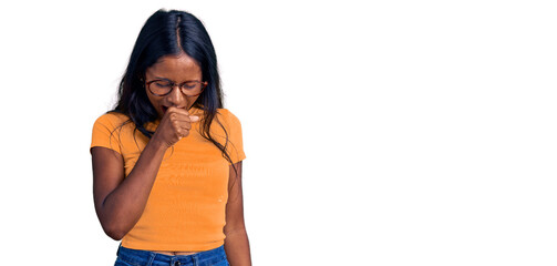 Young indian girl wearing casual clothes and glasses feeling unwell and coughing as symptom for...