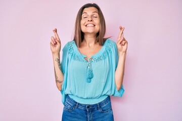 Beautiful caucasian woman wearing casual clothes gesturing finger crossed smiling with hope and eyes closed. luck and superstitious concept.