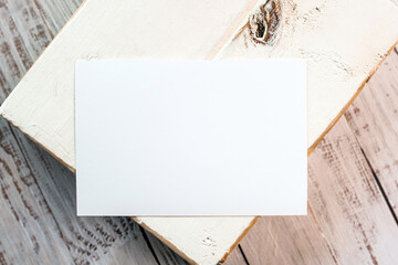 Photo of blank white card on a  wooden block. Blank template for brand identity mock-up design, food theme. Presentation and portfolio template