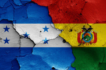 flags of Honduras and Bolivia painted on cracked wall