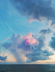 Beautiful cloudy sunset in the Caribbean Sea, the sunset produces pastel blue, orange and pink colors.