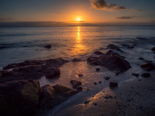 Fototapeta na wymiar Beautiful Seaside Sunrise with Reflections and Rocks