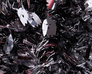 Scary tinsel in silver and black with shrieking ghosts. Fun Halloween background