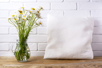 Pillow mockup with daisy wildflowers