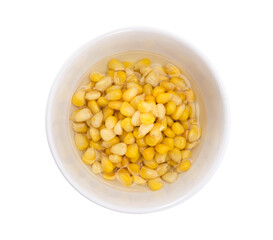 Bowl of corn seed in water isolated on white