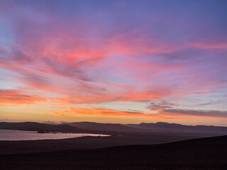 Obraz premium Sunset in Paracas, bay and natural reserve of Ica in Peru. Sea, water, birds, dock, stones.