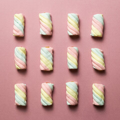 Colorful marshmallow on pink background. flat lay, top view. Delicious snacks pattern background