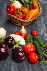 Assortment of fresh home-made vegetables on a dark table