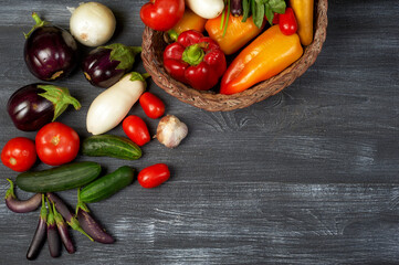 Assortment of fresh home-made vegetables on a dark table