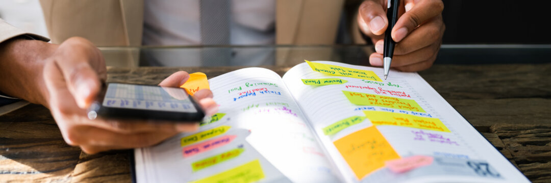 African Man Organizing Appointment Calendar Schedule