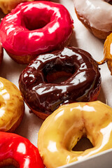 Collection of many colored donuts in a box