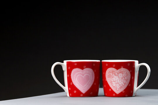 Red coffee mugs with a symbolic image of the heart. Valentine's Day mugs.
