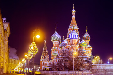 Fototapeta premium St. Basil's Cathedral in Moscow. Sights of Russia. Streets of Moscow at night. Winter capital. Different-sized domes of St. Basil's Cathedral. Travels in evening Moscow. Christmas holidays in Russia.