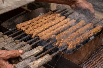 Sheekh Kabab being cooked over a charcoal grill