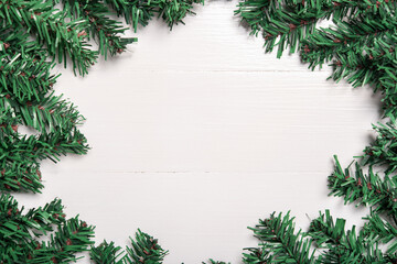 Fototapeta na wymiar artificial Christmas tree leaf decorate on white wooden background