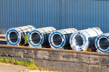 Sale of metal sheet. Production of metal sheet. Sale of metal. Rolls of sheet iron lie on the...