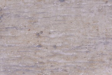 A grey wall with linear rough texture