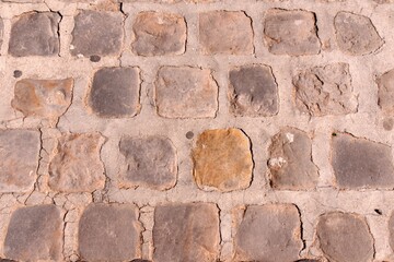 A view of an ancient or a very old wall of rural area made up of different sizes of bricks and also diverse in colors square in shapes