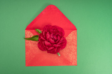 A rose in a red envelope. Love letter. Declaration of love. Valentine day. Flower in the envelope. Gift. Engagement. Wedding invitation. A romantic message.