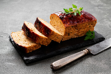 Tasty homemade ground baked chicken meatloaf glazed with barbeque sauce .	