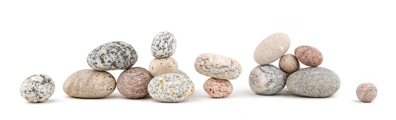 Fototapeta na wymiar Sea smooth oval pebbles isolated on white background. Heap of stacked round pebbles.