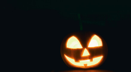 The halloween pumpkin shining in the dark