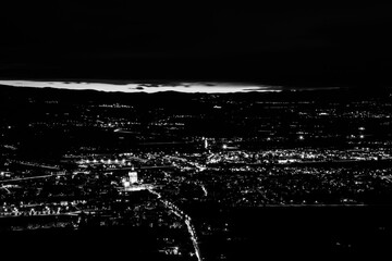 Aerial view of Umbria (Italy) valley at night, with city lights and S.M.degli Angeli Assisi church