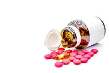 Pile of medicine pills and drug capsules with pill bottles on white background.