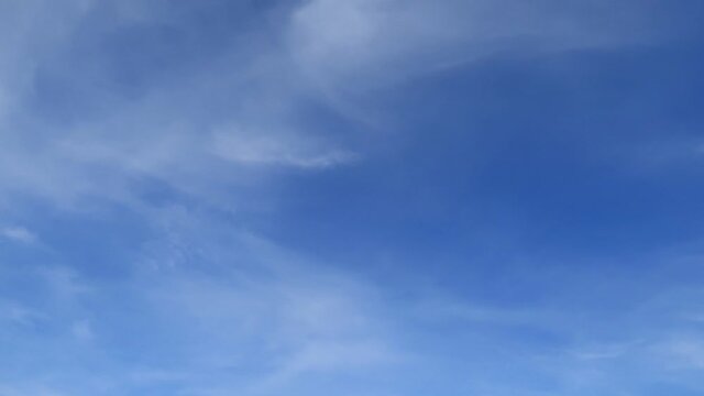 Beautiful sunny clear blue sky background with white cirrus or cirrocumulus cloud & cumulus or cirrostratus cloudscape moved on daylight horizon in tropical summer or spring sunlight, B-roll TimeLapse