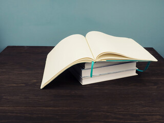 Open book on blue background, open pages as a concept of new knowledge, online self-study