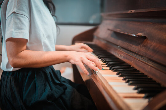 Close Up Of Woman Hands Playing Piano