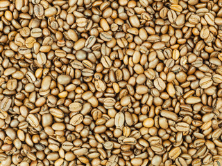 Large quantities of coffee beans as a background with place for text
