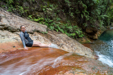 Person resting at the top of the waterfall