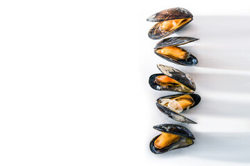 Food background with a row of cooked blue mussels with long shadows on a white surface, large copy...
