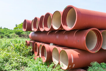 front circular view of ductile iron pipes stocked in open space go-down.
