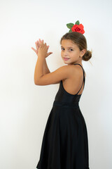 Little girl dancing flamenco in traditional flamenco dress