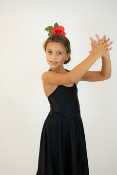 Little girl dancing flamenco in traditional flamenco dress