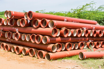 ductile iron pipes stocked in open space of a rural village store yard.
