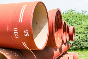 ductile iron pipes stocked in open space of a rural village store yard.
