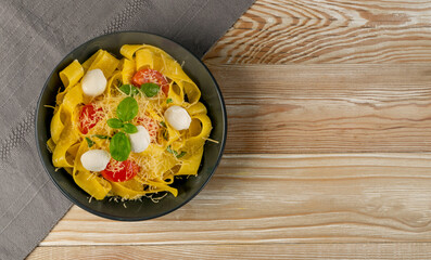Yellow italian pasta pappardelle, fettuccine or tagliatelle