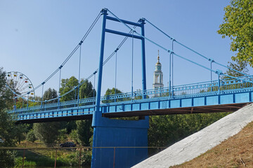 Pedestrian bridge in Tambov over the Tsna river on a sunny summer day