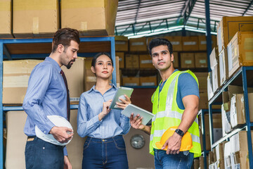 White Caucasian Manager of warehouse worker assign and discuss with Asian assistant manager woman and Indian Worker man in local factory, Partner and colleague working together concept
