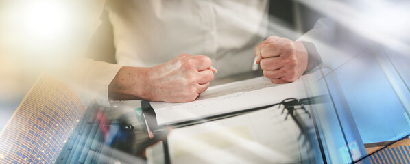 Angry businesswoman at her workplace; multiple exposure