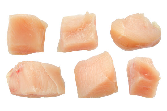 Raw chicken fillet pieces, top view, isolated. Collection of raw diced chicken breasts on white. Chicken meat cubes set. Chicken fillet isolated on white background cubes.